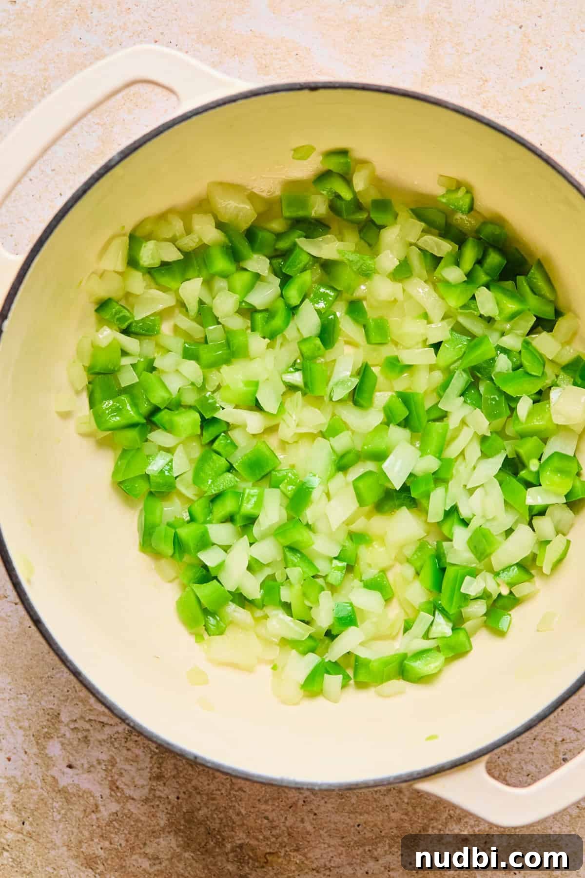 One-Pot Chili Mac: Cheesy Beef Skillet Dinner 5 Onion and green bell pepper sautéed in pot.