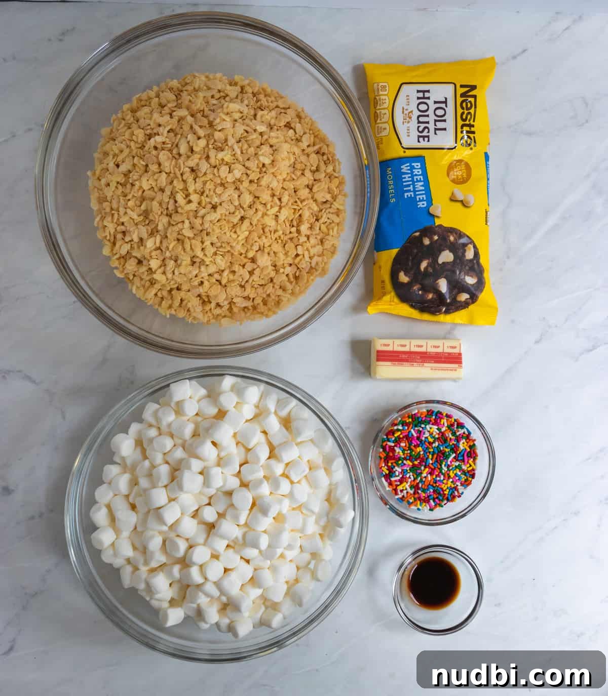 Funfetti Rice Krispie Treats Recipe for Colorful Party Snacks 3 Cereal, marshmallows, sprinkles, white chocolate and ingredients on counter.