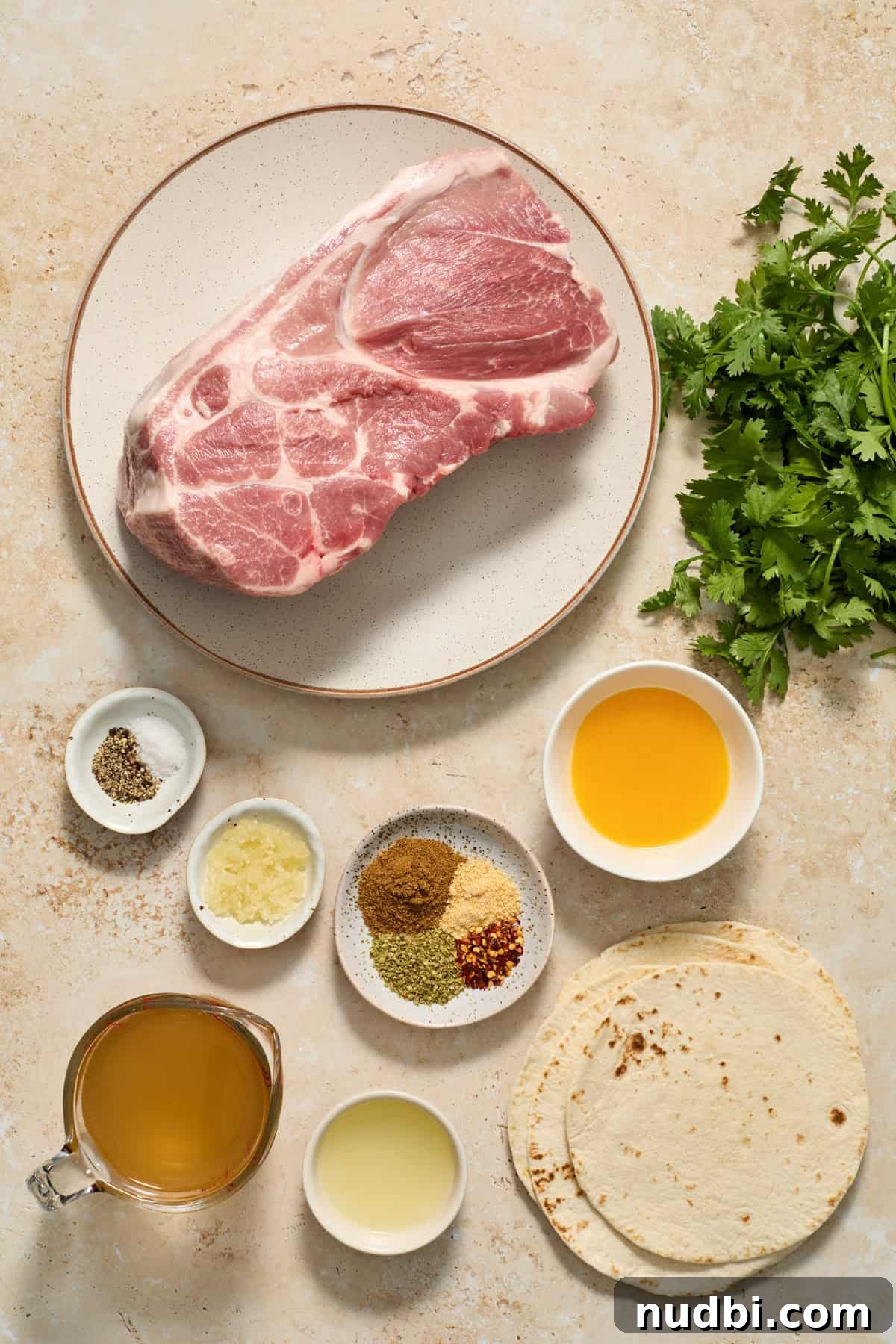 Crispy Instant Pot Carnitas Recipe for Tender, Crunchy Pork 3 Pork shoulder on plate along with tortillas, cilantro, broth, orange juice and other ingredients.