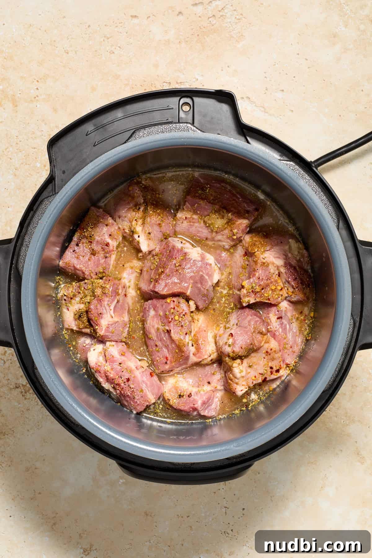 Crispy Instant Pot Carnitas Recipe for Tender, Crunchy Pork 5 Instant Pot with pork, broth and seasoning.