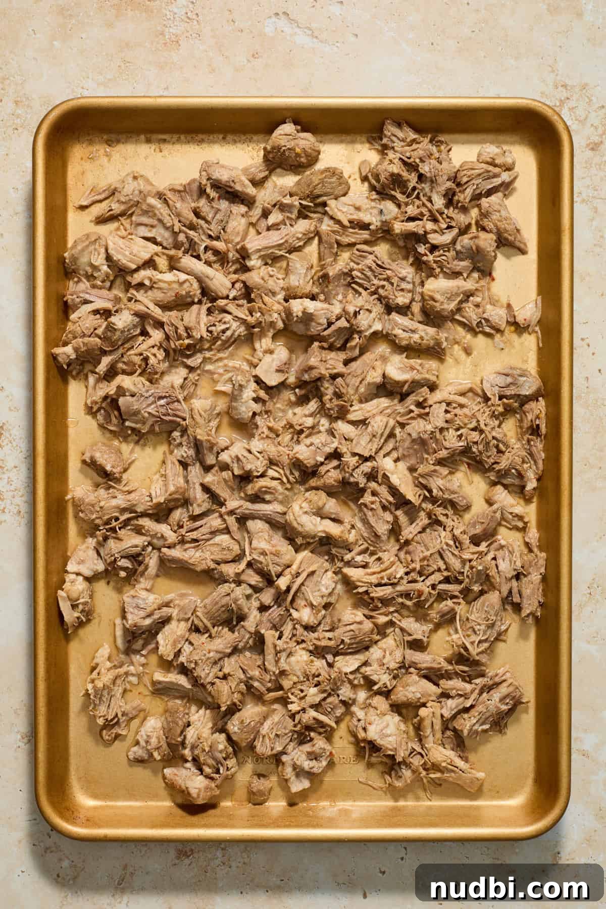 Crispy Instant Pot Carnitas Recipe for Tender, Crunchy Pork 8 Sheet pan with shredded pork.