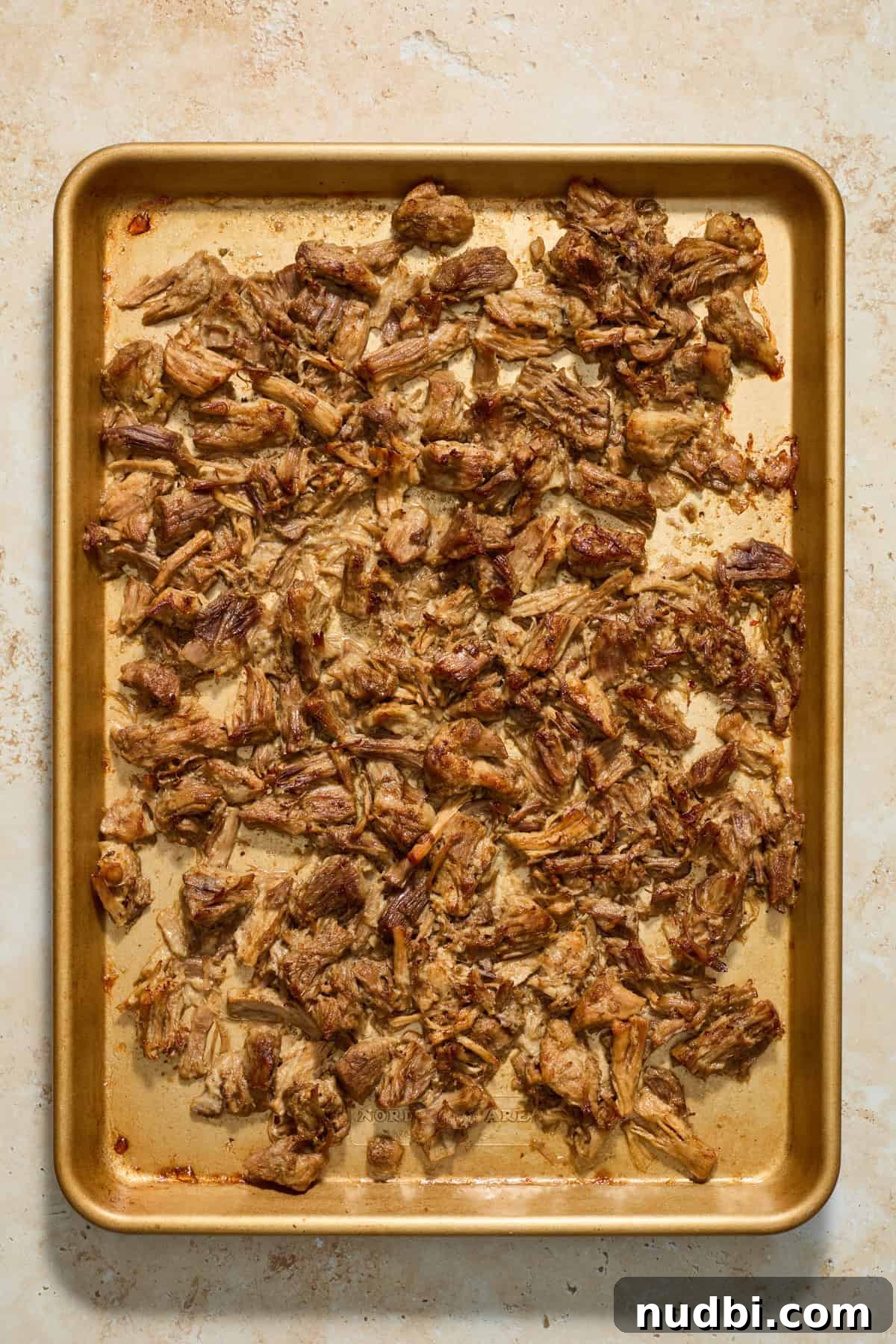 Crispy Instant Pot Carnitas Recipe for Tender, Crunchy Pork 9 Sheet pan with shredded pork after broiling.