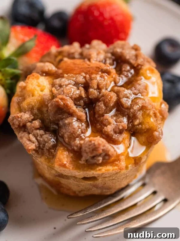 Cinnamon Raisin Bagel Recipe: Homemade Soft Chewy Bagels 16 Baked French toast muffin with streusel topping on plate with maple syrup poured over top.
