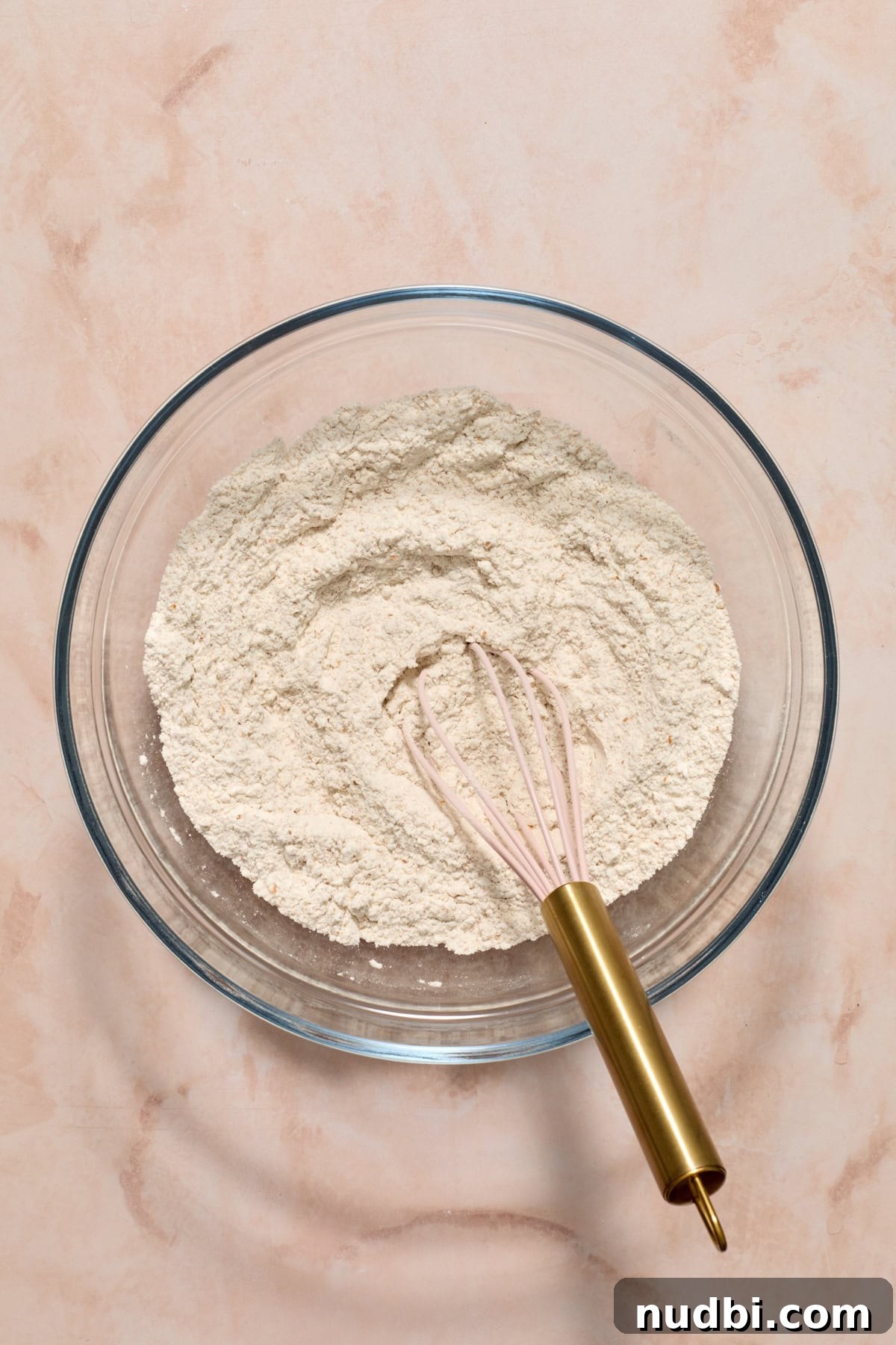 Cinnamon Raisin Bagel Recipe: Homemade Soft Chewy Bagels 4 Whisk in glass mixing bowl with dry igredients.
