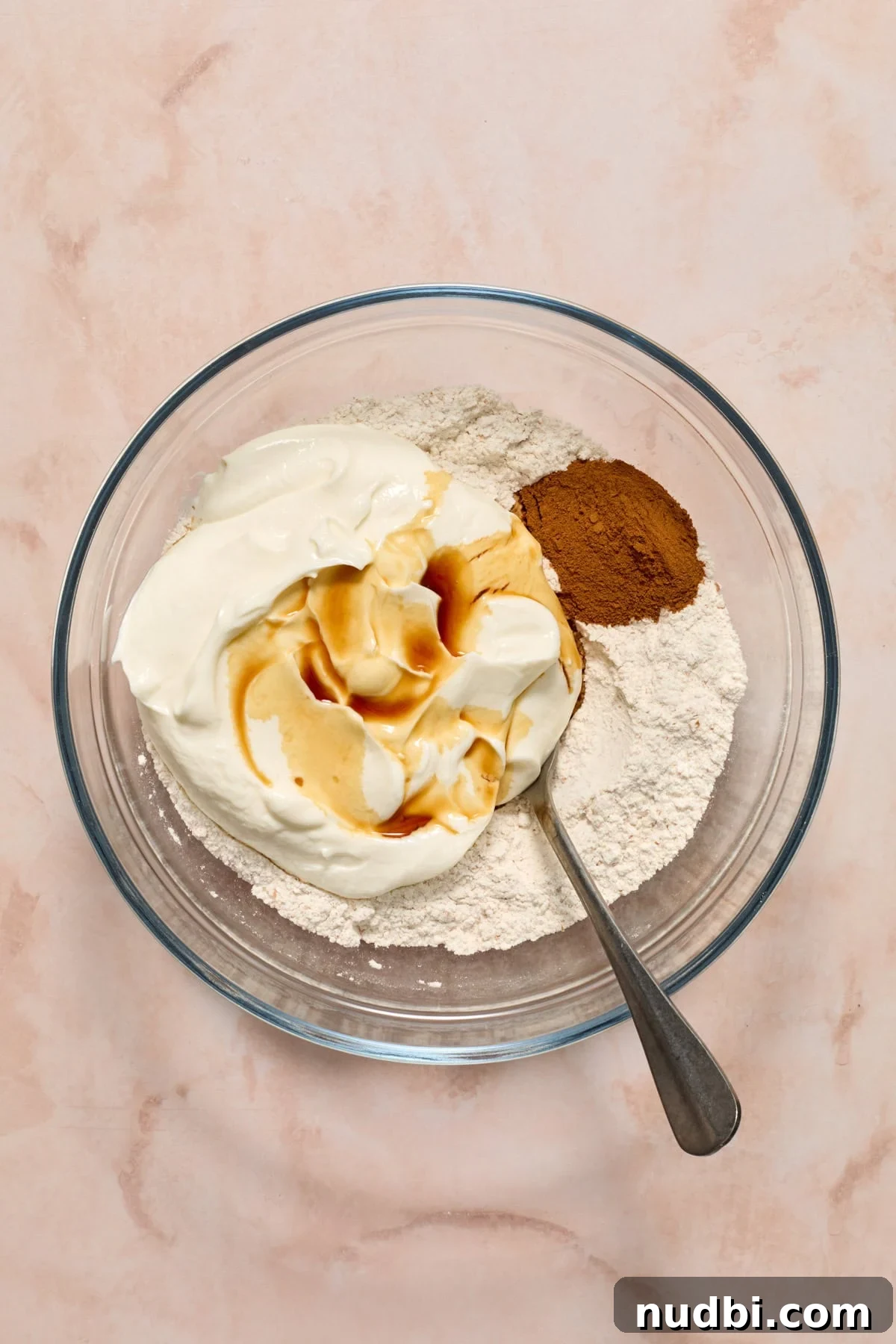 Cinnamon Raisin Bagel Recipe: Homemade Soft Chewy Bagels 5 Spoon in bowl with cinnamon, greek yogurt, vanilla and dry ingredients.
