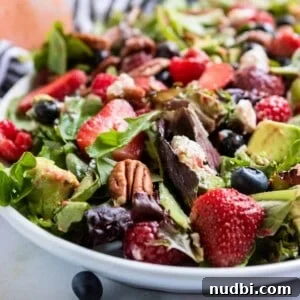 Mixed Greens with Berries and Strawberry Balsamic Dressing 8 Berries and pecans over green salad.
