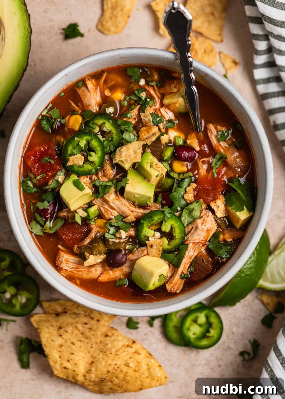 Instant Pot Chicken Tortilla Soup Recipe 2 Soup bowl with Instant Pot Chicken Tortilla soup topped with cilantro, tortilla chips, jalapeño, etc.
