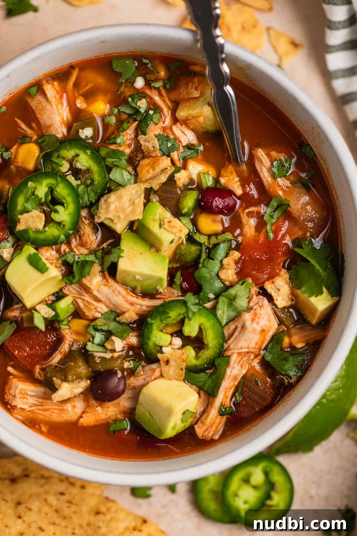 Instant Pot Chicken Tortilla Soup Recipe 11 Instant pot chicken soup with avocado, tortilla chips and cilantro over top.