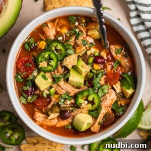 Instant Pot Chicken Tortilla Soup Recipe 12 Overhead view of bowl that has chicken soup with beans, peppers, corn, etc.