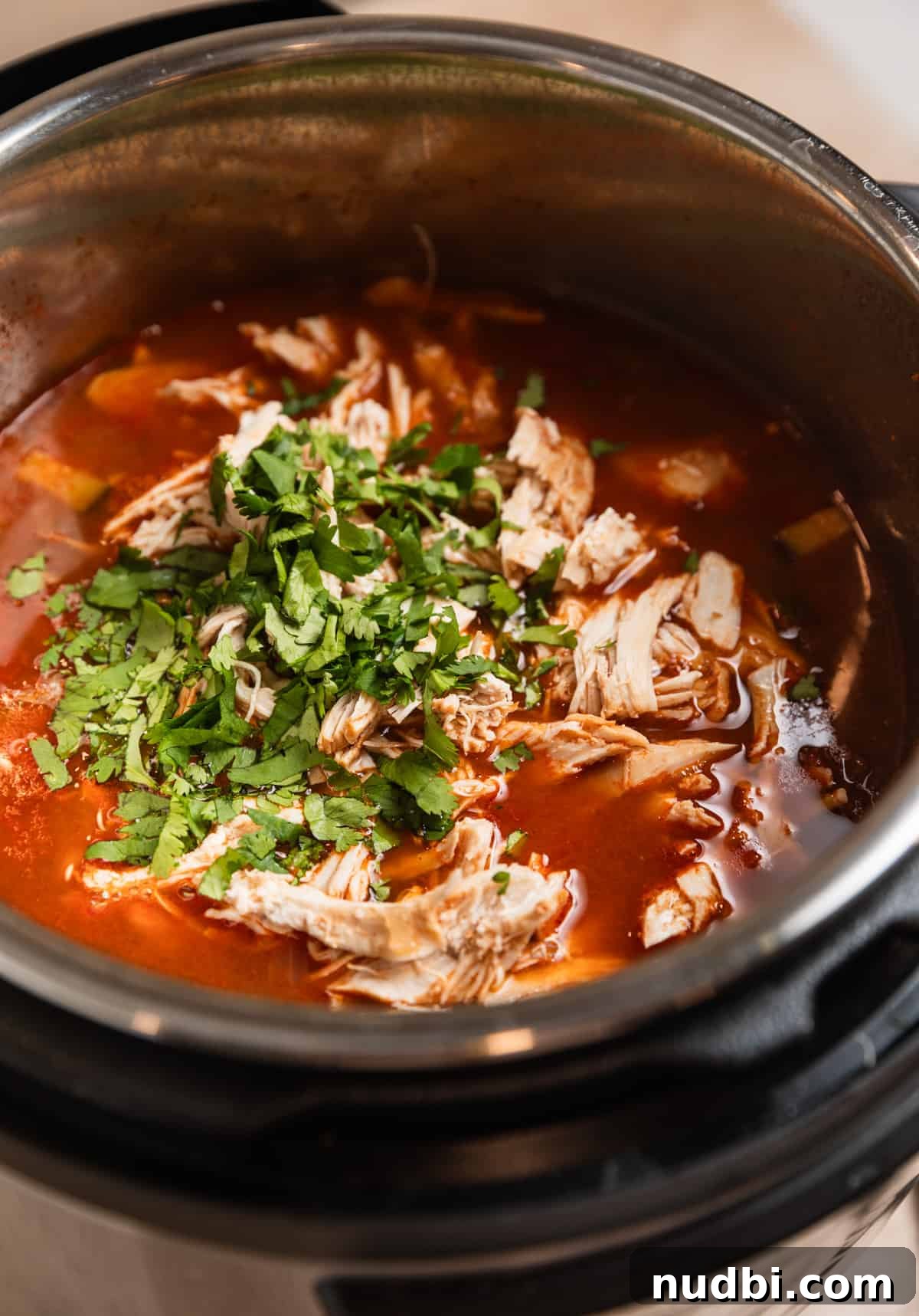 Instant Pot Chicken Tortilla Soup Recipe 9 Shredded chicken and cilantro added to Instant Pot with soup.