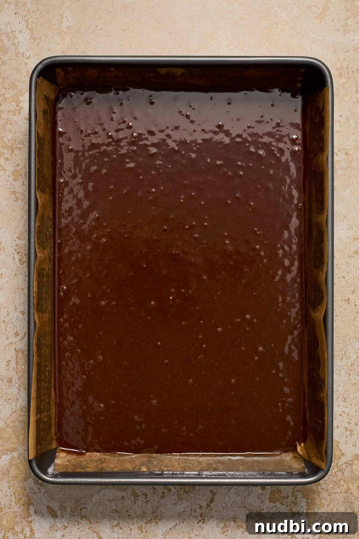 Kahlúa Cream Cheese Brownies Recipe — Luscious Coffee-Chocolate Swirl 5 Brownie batter in parchment lined baking pan before baking.