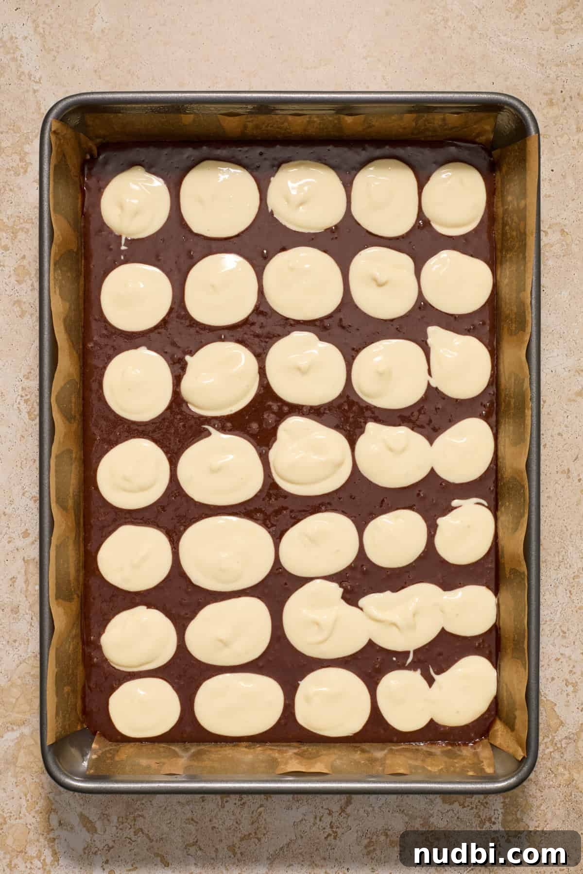 Kahlúa Cream Cheese Brownies Recipe — Luscious Coffee-Chocolate Swirl 8 Brownie mix with cheesecake mixture dollops throughout pan.