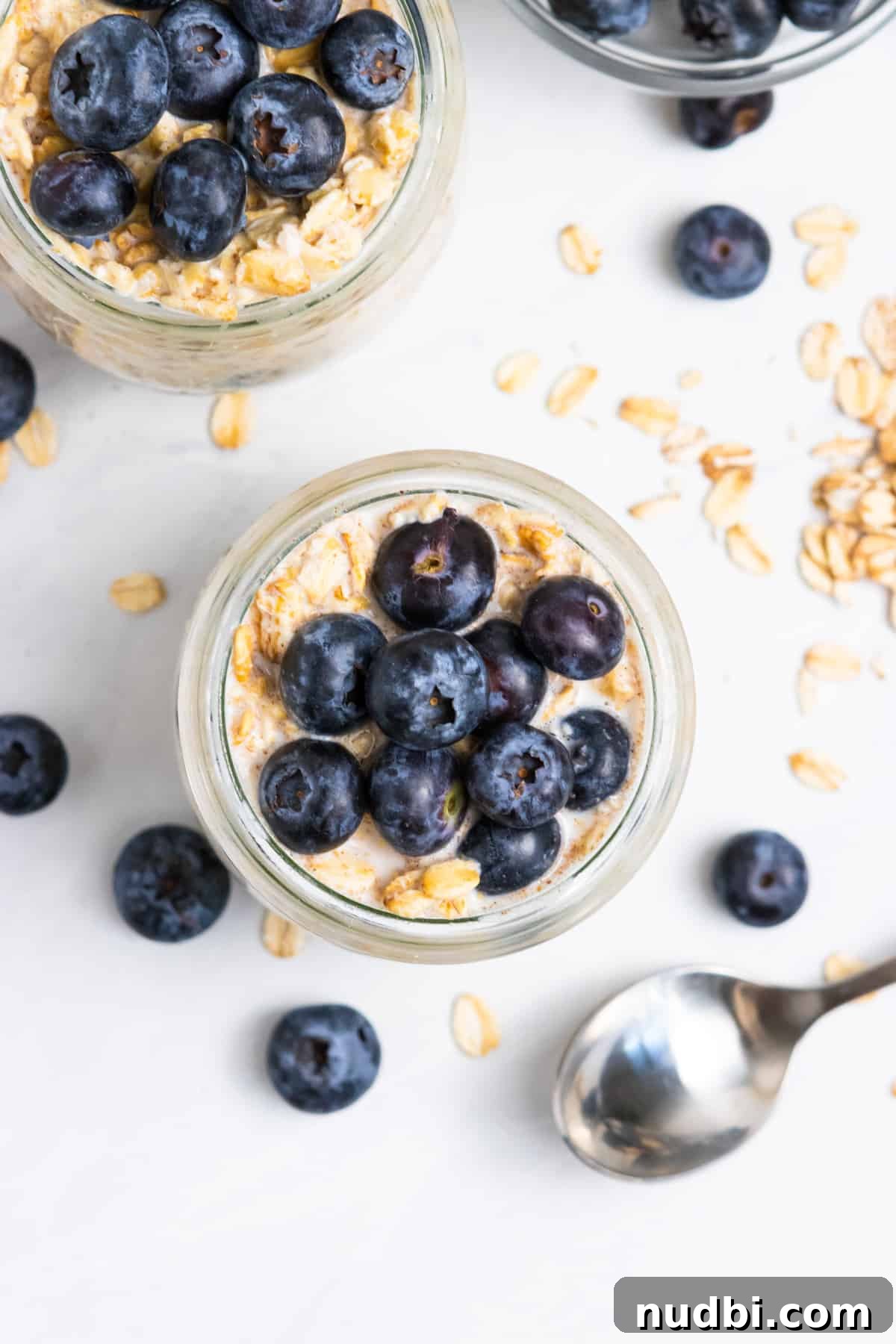 Blueberry Muffin Overnight Oats Recipe for Quick Morning Meals 3 Overhead shot of oatmeal with spoon.