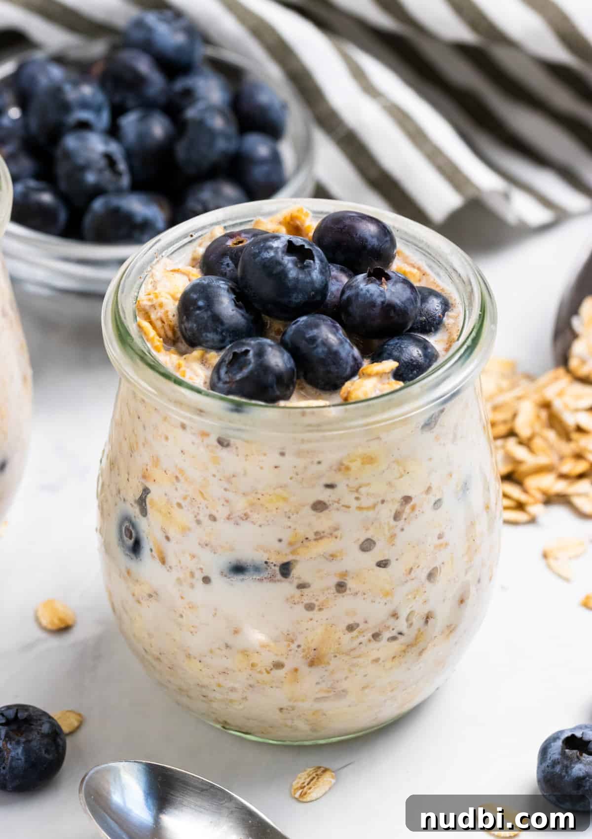 Blueberry Muffin Overnight Oats Recipe for Quick Morning Meals 4 Oatmeal in jar with blueberries on top.