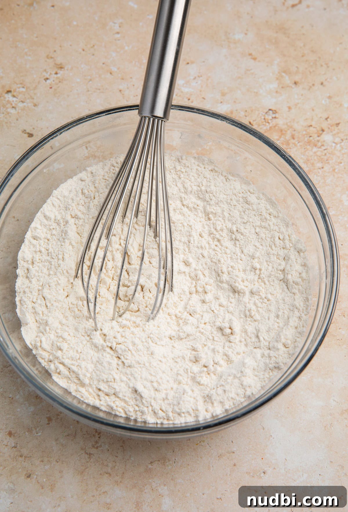 Coconut Banana Chocolate Chip Bread Recipe 5 Dry ingredients mixed in glass bowl with whisk.