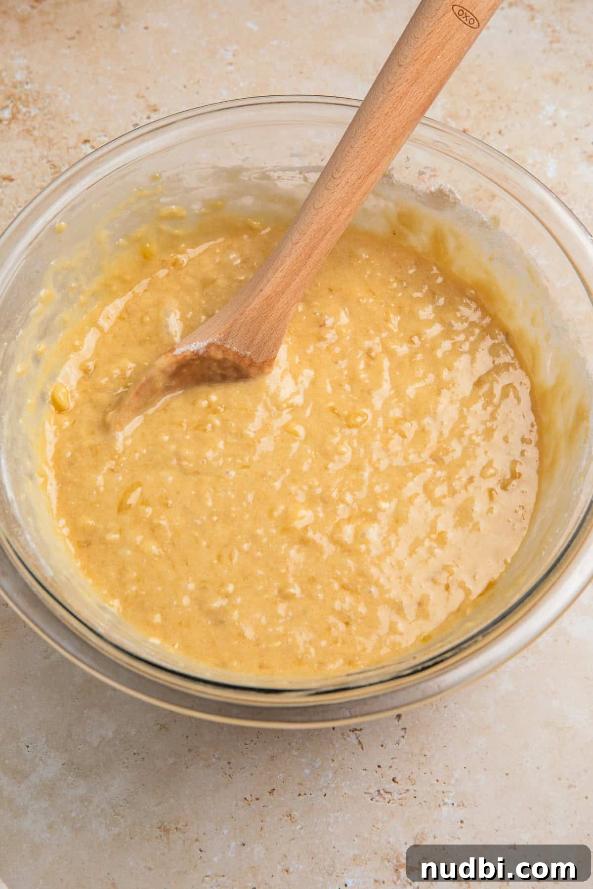 Coconut Banana Chocolate Chip Bread Recipe 8 Dry ingredients added to wet ingredients in bowl.