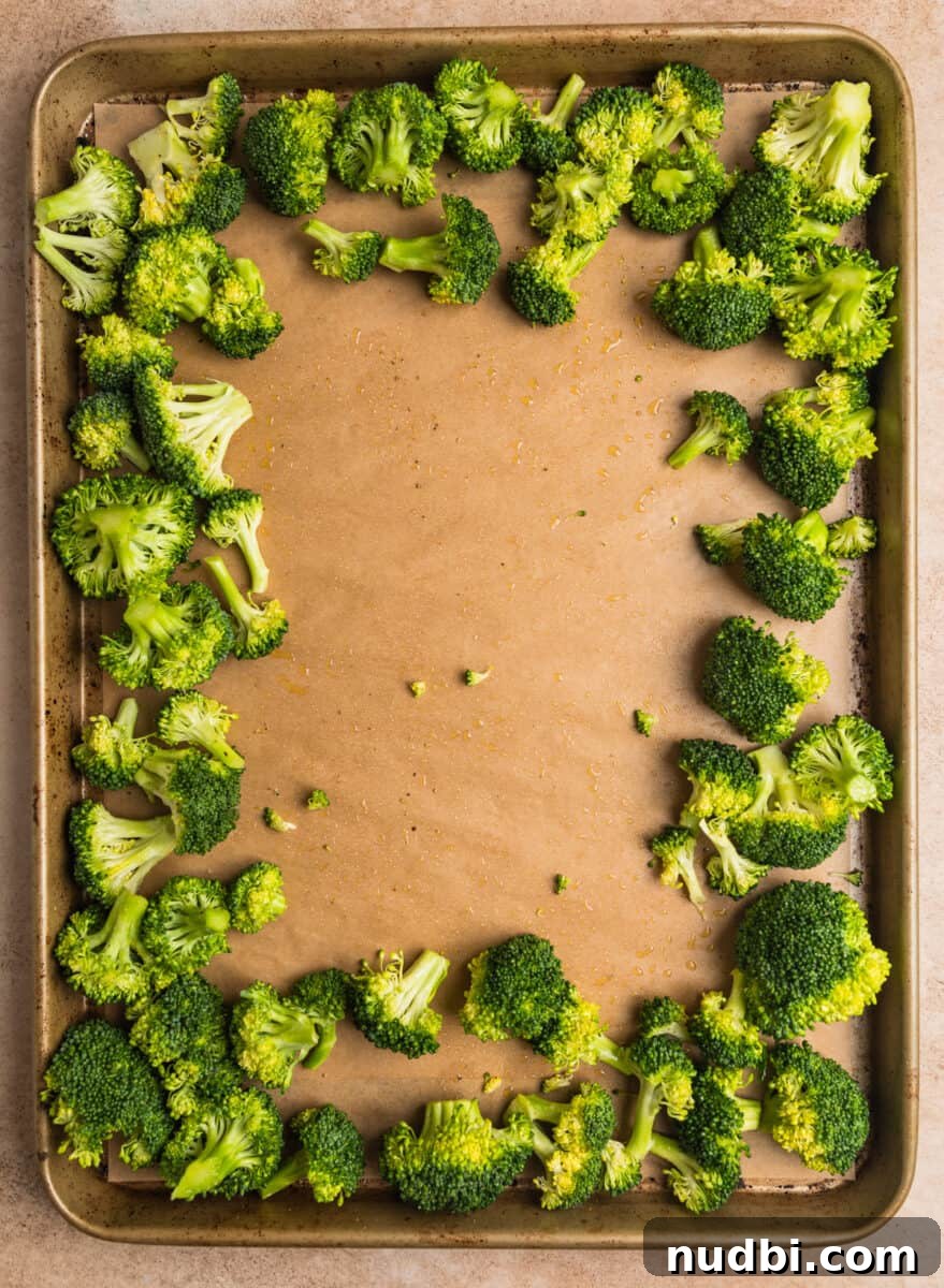 Sticky Orange Sheet Pan Chicken Dinner 8 Broccoli spread to the outer edges of baking sheet.
