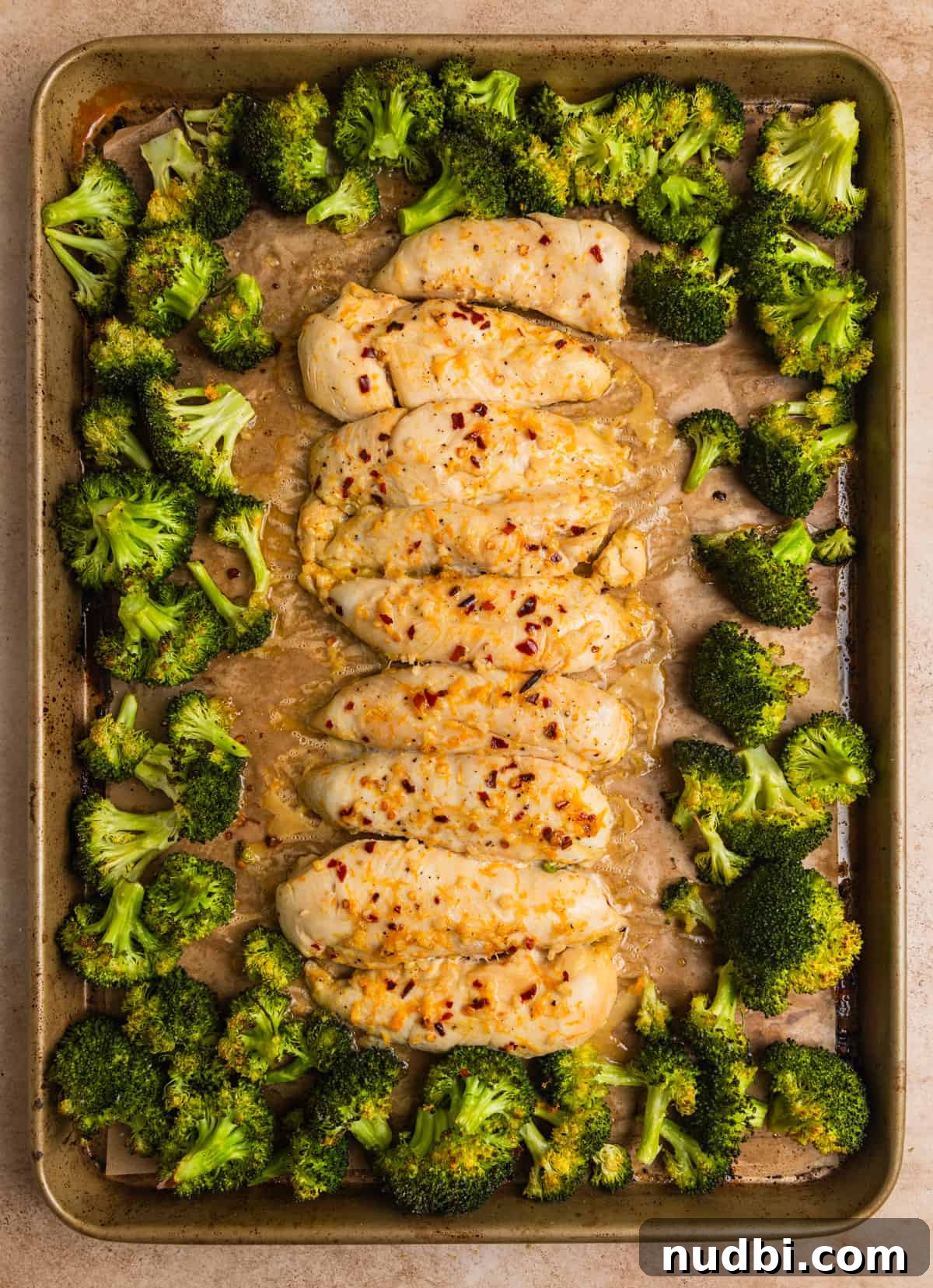Sticky Orange Sheet Pan Chicken Dinner 10 Baked orange chicken sheet pan dinner after being baked with cooked broccoli.