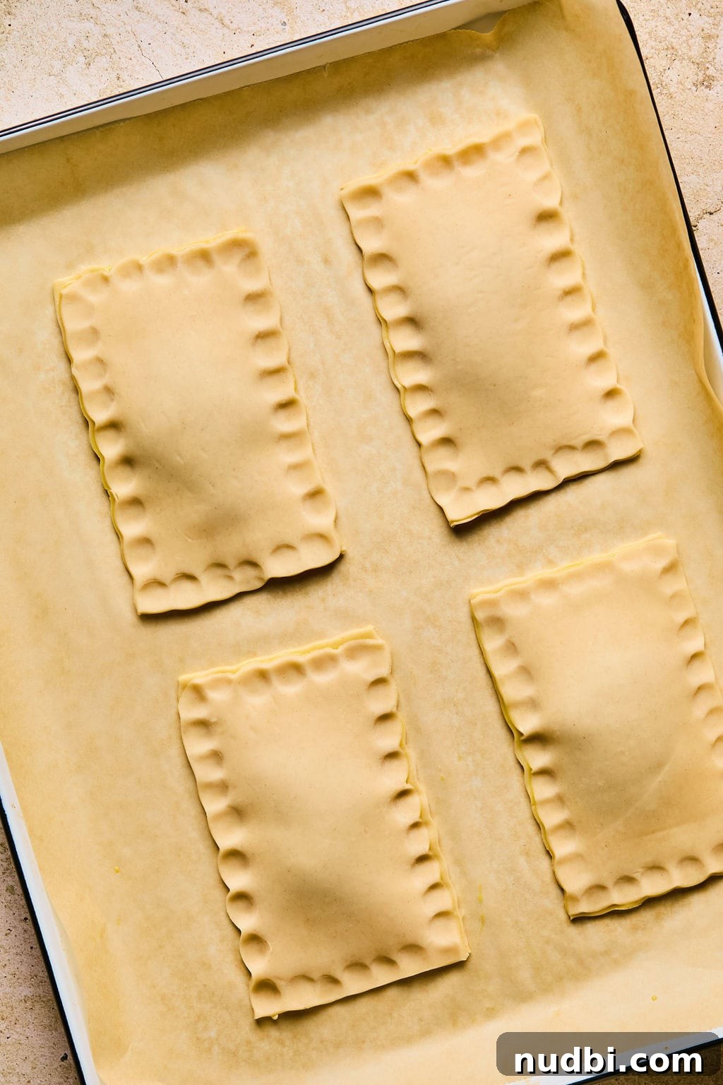 Homemade Pop-Tarts Made with Flaky Pie Crust — Sweet Breakfast Pastry 11 Crimped edges of pie crust for breakfast pastries.