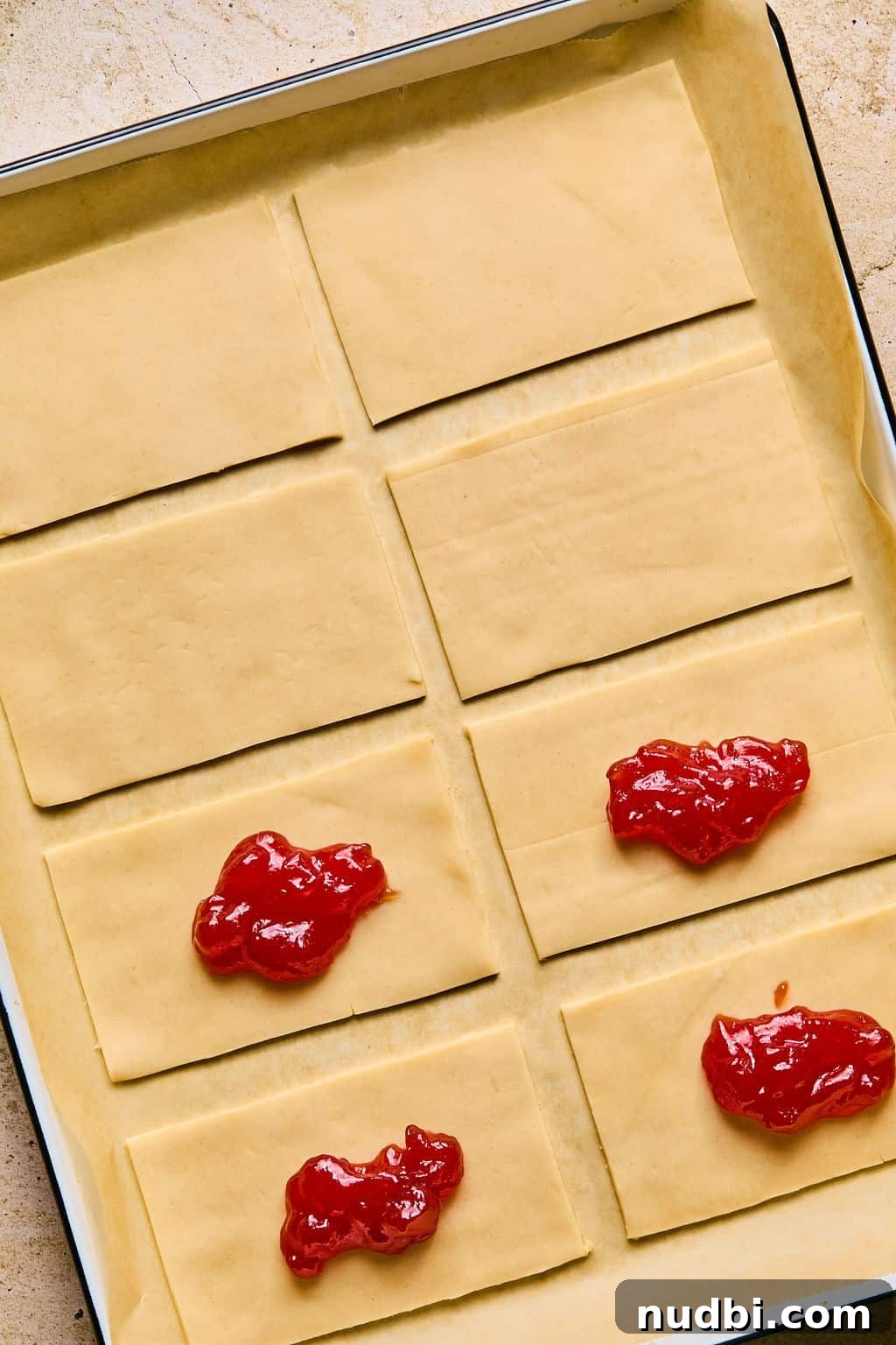 Homemade Pop-Tarts Made with Flaky Pie Crust — Sweet Breakfast Pastry 8 Jam on pieces of pie crust.