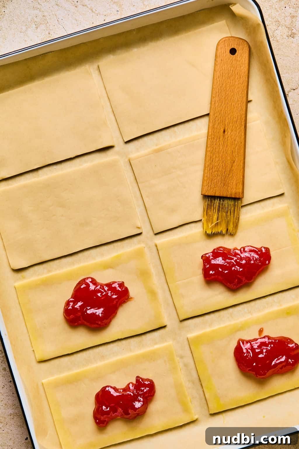 Homemade Pop-Tarts Made with Flaky Pie Crust — Sweet Breakfast Pastry 9 Brush with egg wash brushing around edges of pie crust.