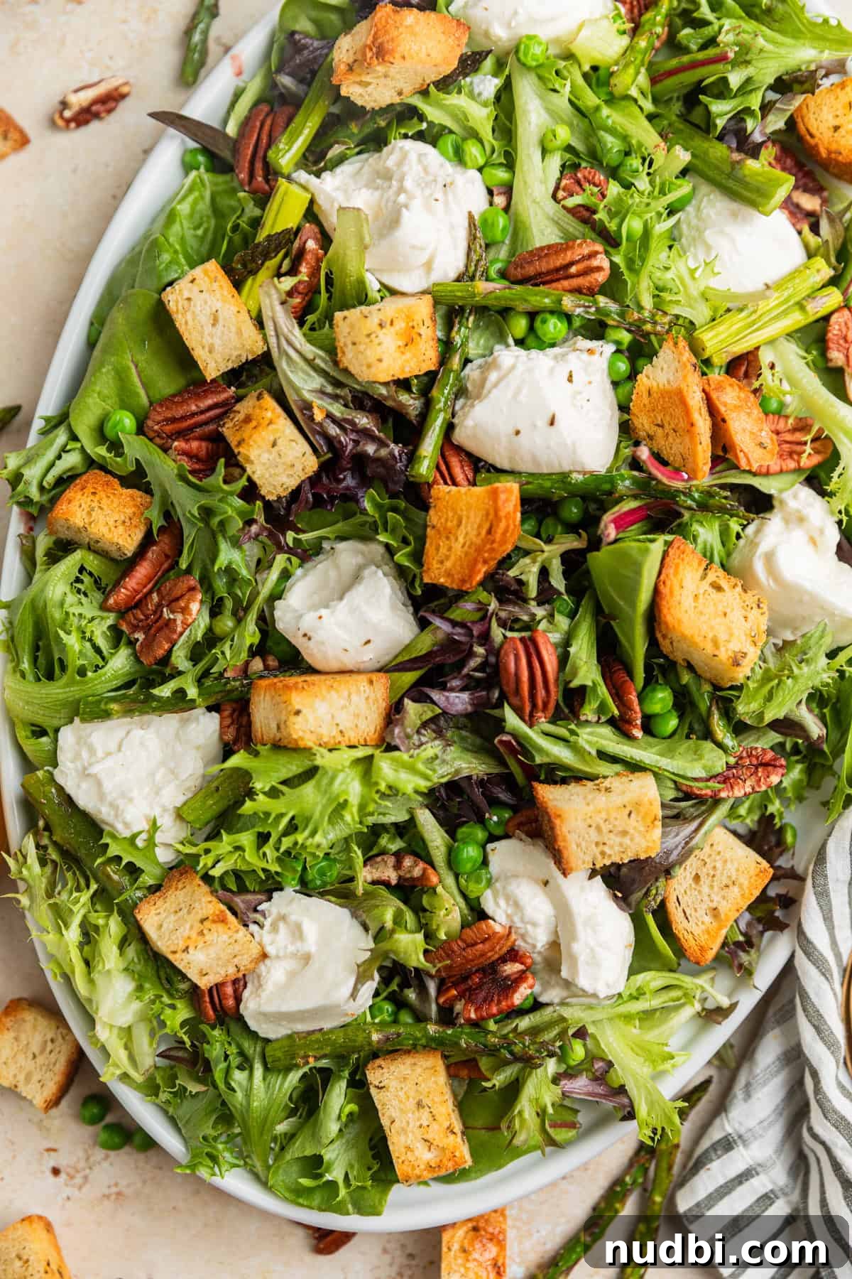 Spring Green Burrata Salad with Lemon Herb Vinaigrette 2 Overhead view of serving platter with spring green and burrata salad.