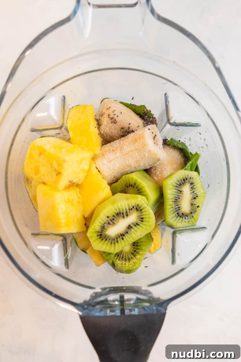 Pineapple Kiwi Smoothie Recipe for Fresh Morning Energy 3 Pineapple, banana, kiwi and other ingredients in blender.