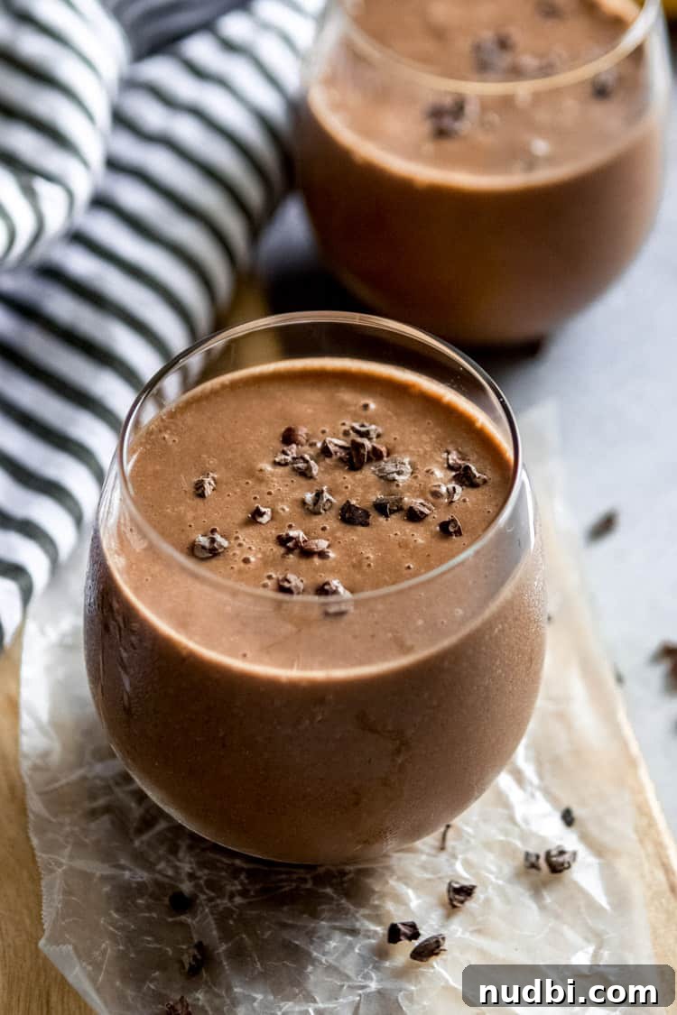 Chocolate Banana Smoothie with a Kick of Cayenne 2 Chocolate Smoothie in glasses with cacao nibs