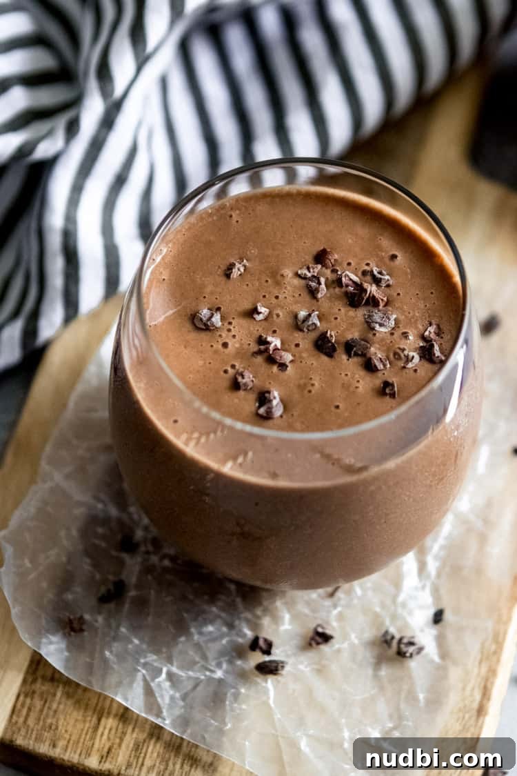 Chocolate Banana Smoothie with a Kick of Cayenne 4 chocolate smoothie in glass with cacao nibs on top