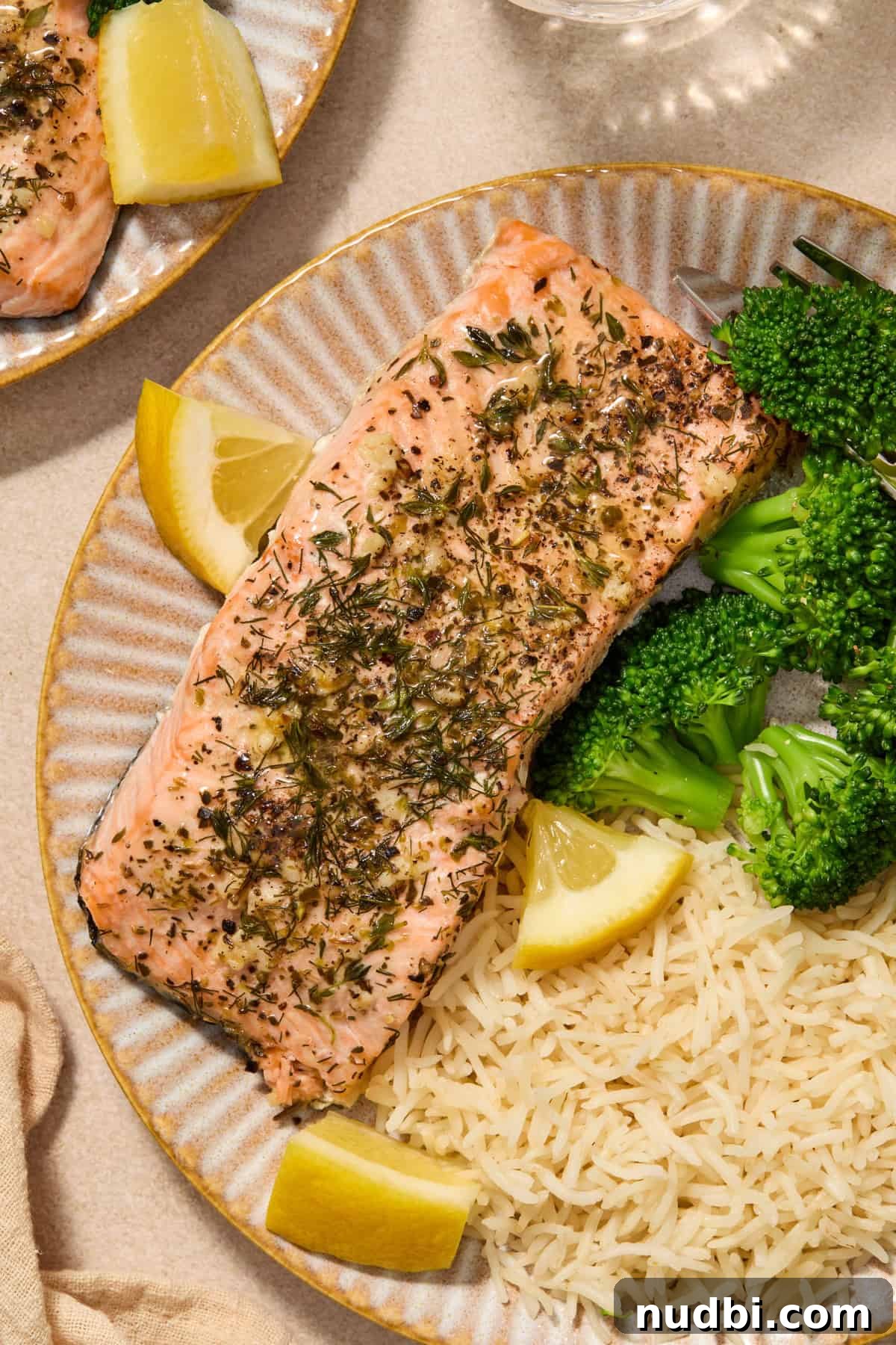 Instant Pot Butter Herb Salmon Recipe for Tender, Flaky Fish 2 Instant pot salmon with butter and herbs on plate with broccoli and rice.