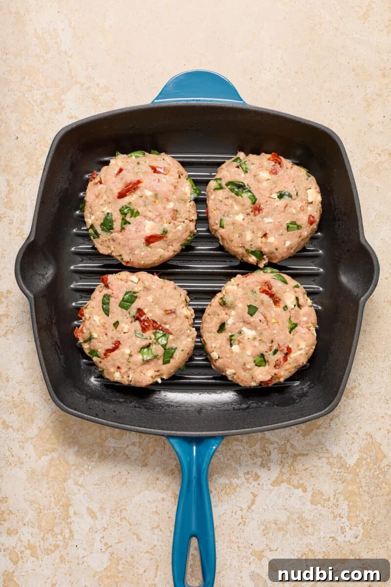 Spinach and Feta Turkey Burgers with Garlic Yogurt Sauce 7 Spinach feta turkey burgers in grill skillet.