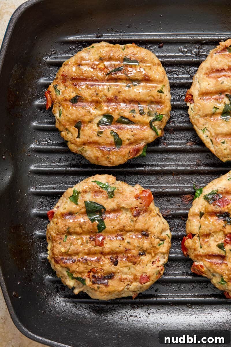 Spinach and Feta Turkey Burgers with Garlic Yogurt Sauce 8 Cooked turkey burgers in grill skillet.
