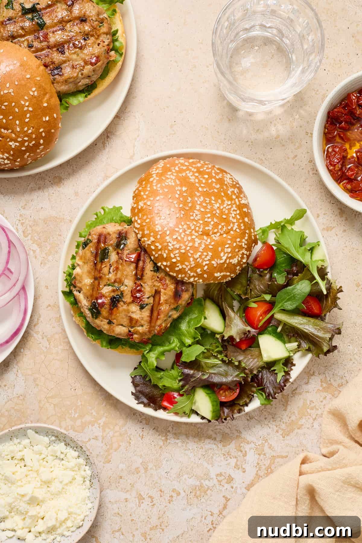 Spinach and Feta Turkey Burgers with Garlic Yogurt Sauce 9 Turkey burger on plate with bun slightly aside to show the burger patty.