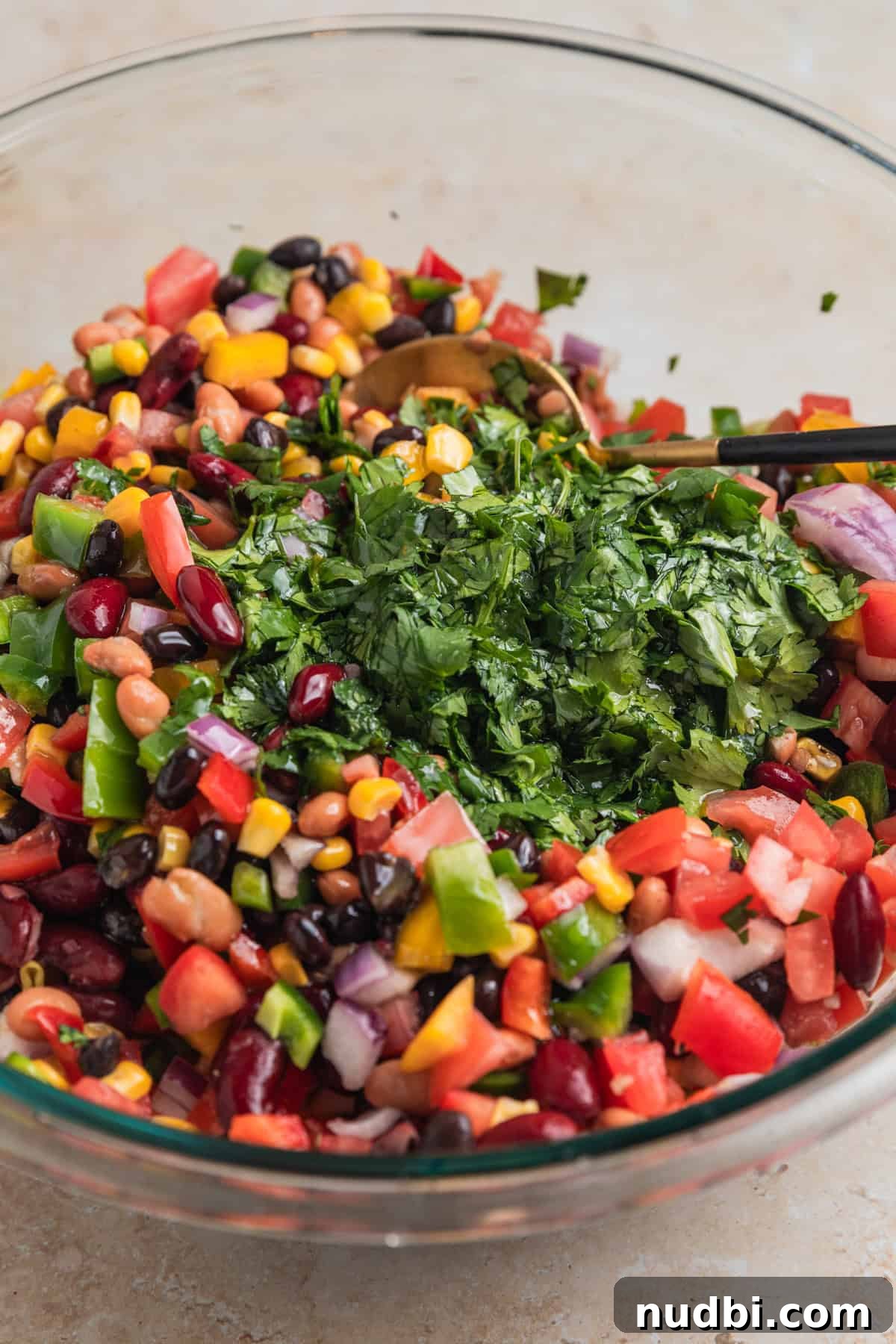 Southwestern Three-Bean, Corn & Avocado Salad Recipe 6 Cilantro chopped and added to mixing bowl with prepped bean and corn salad.