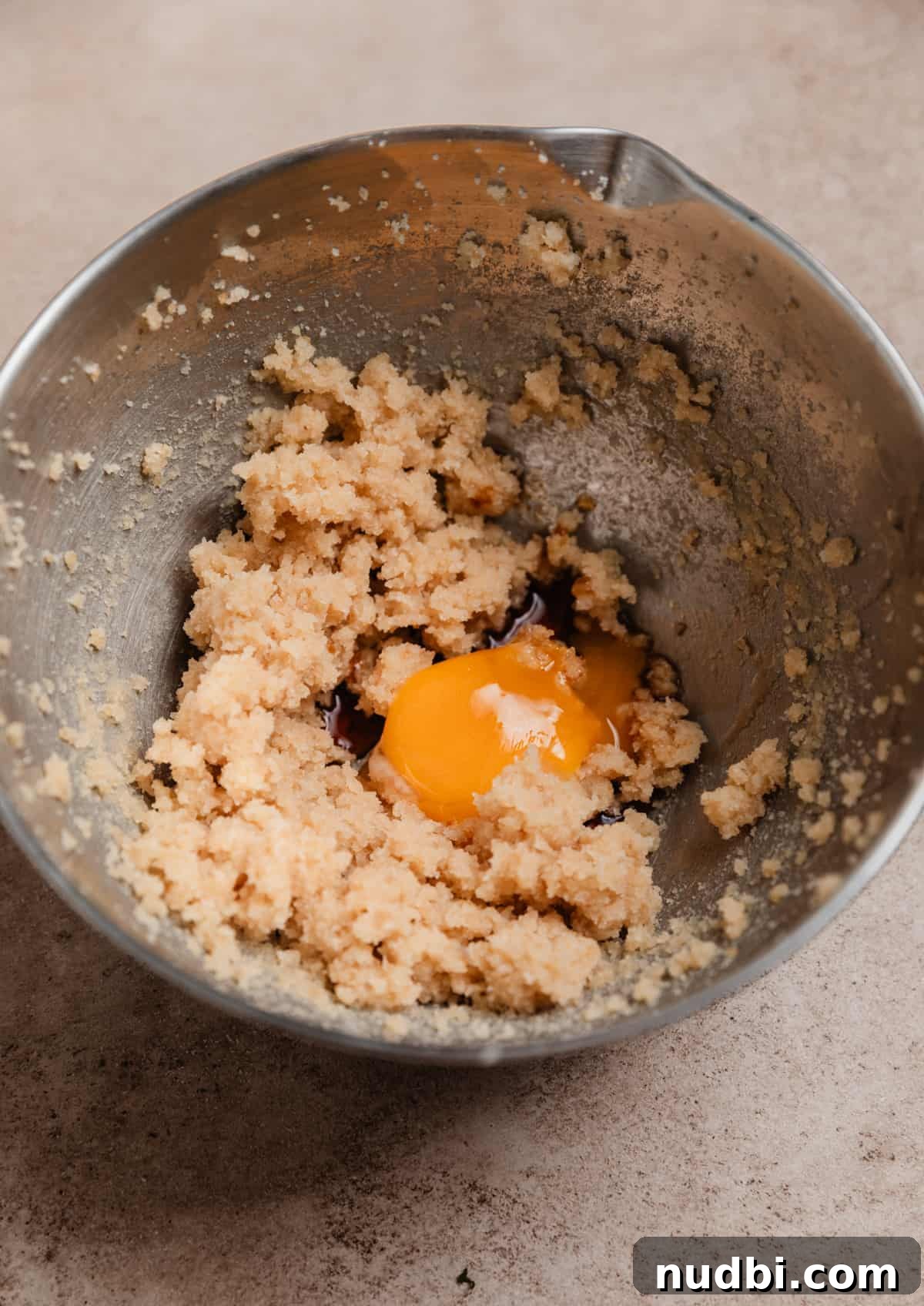 Small-Batch One-Bowl Chocolate Chip Cookies 3 Creamed butter and sugar in mixing bowl with egg yolk and vanilla added.