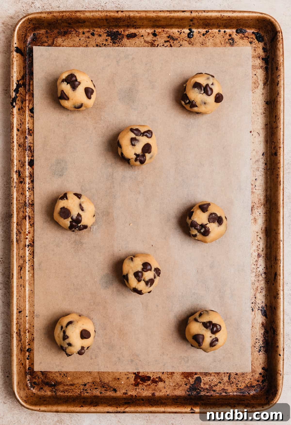 Small-Batch One-Bowl Chocolate Chip Cookies 7 Cookie dough balls lined on parchment lined baking sheet.