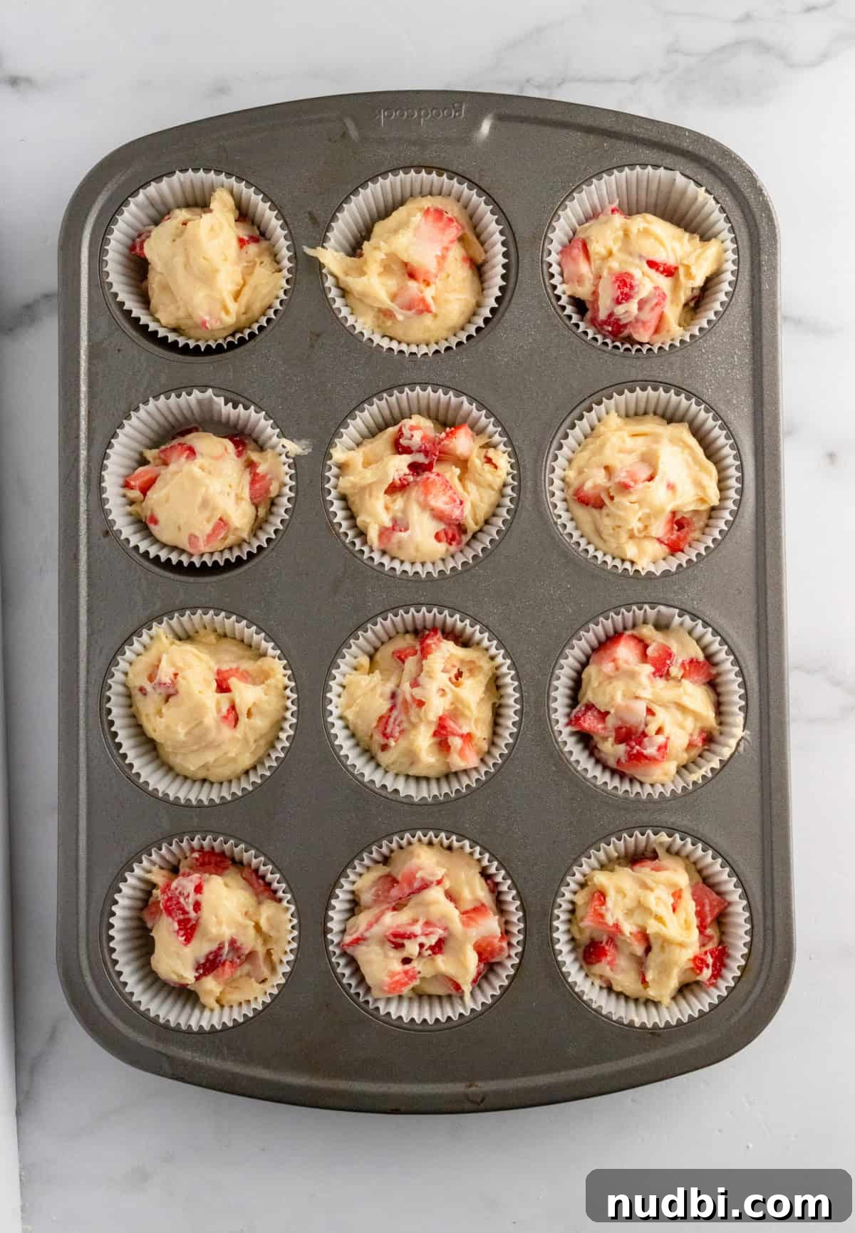 Strawberry Crumble Muffins: Moist Muffins with Crunchy Topping 11 Strawberry muffins in pan before crumb topping added.