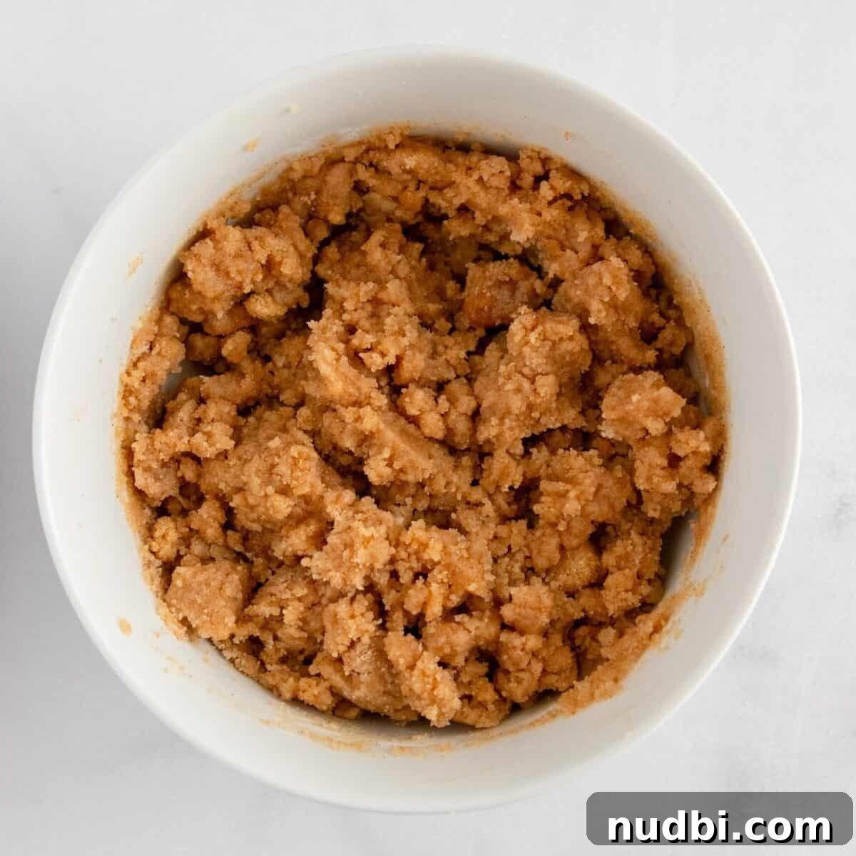 Strawberry Crumble Muffins: Moist Muffins with Crunchy Topping 10 Crumble mixture in white bowl.