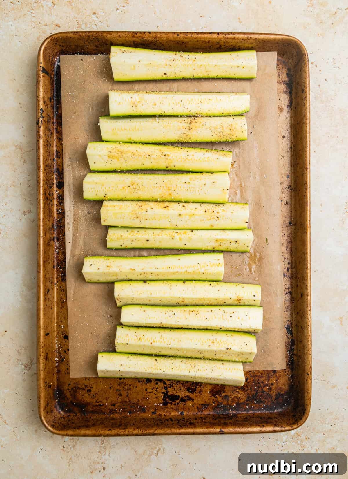 Grilled Zucchini Pasta Salad with Lemon Garlic Dressing 4 Seasoned zucchini pieces on parchment lined sheet pan.