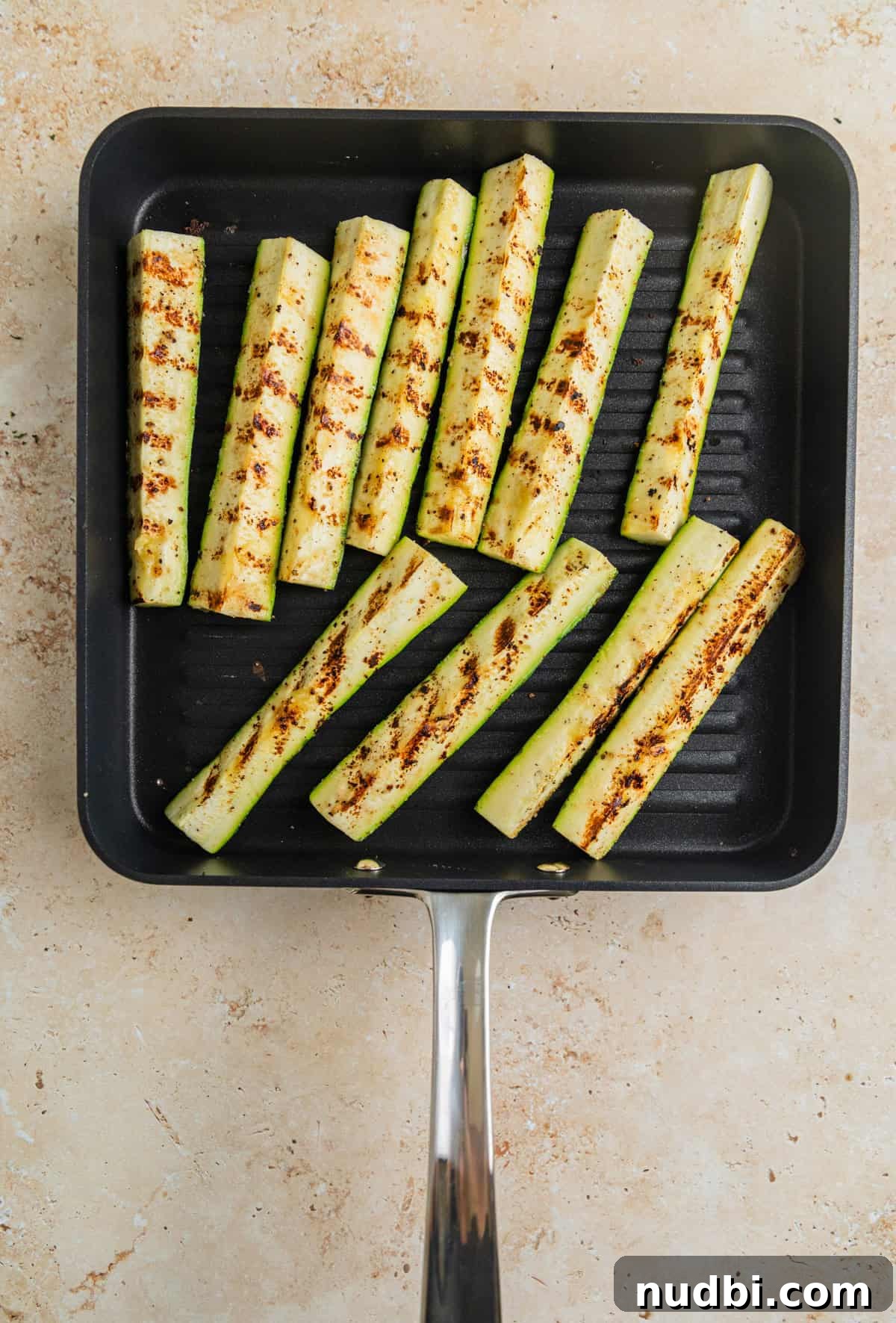 Grilled Zucchini Pasta Salad with Lemon Garlic Dressing 5 Zucchini pieces on grill pan.