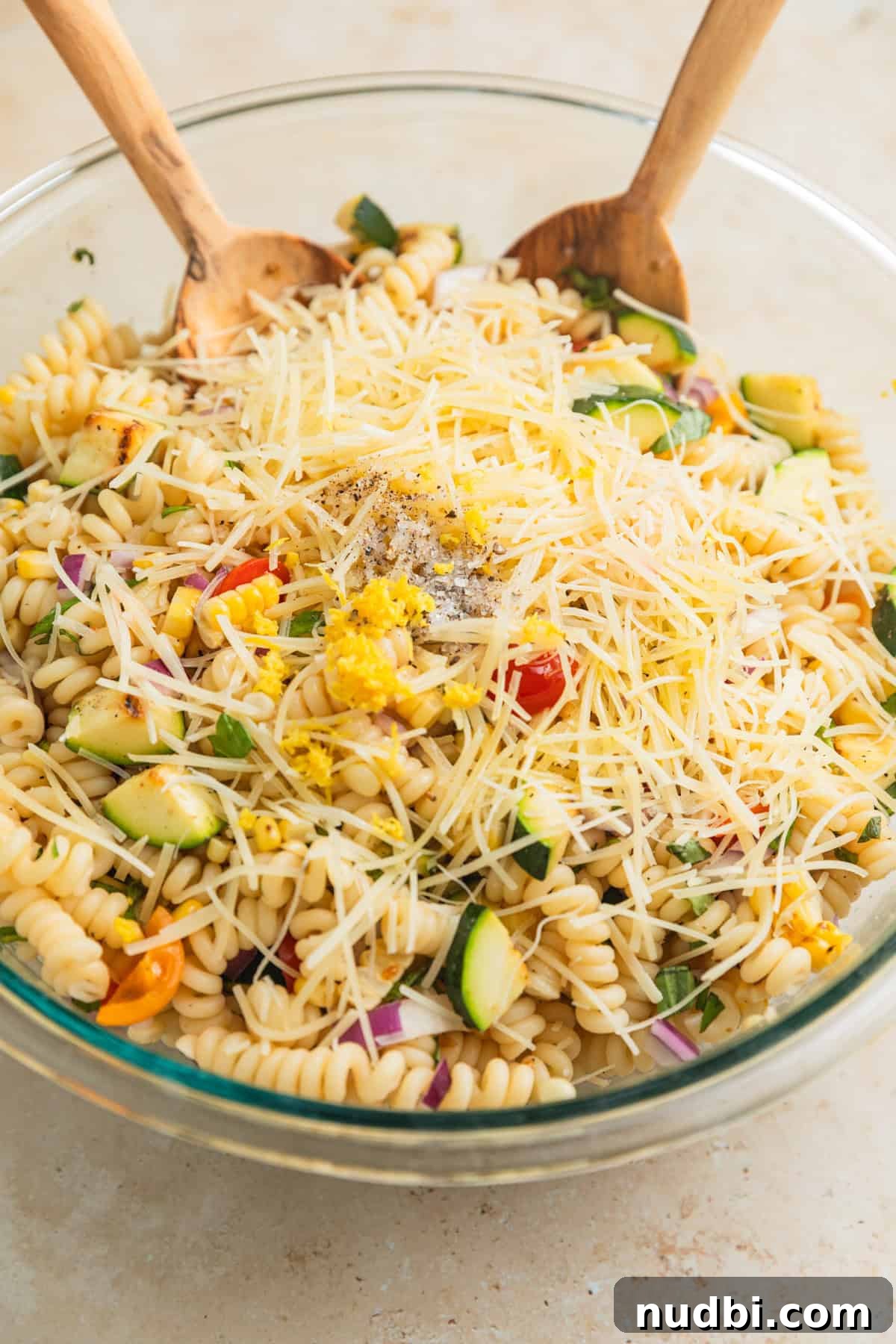 Grilled Zucchini Pasta Salad with Lemon Garlic Dressing 8 Tossed zucchini pasta salad topped with shredded parmesan cheese, olive oil, lemon zest and more.