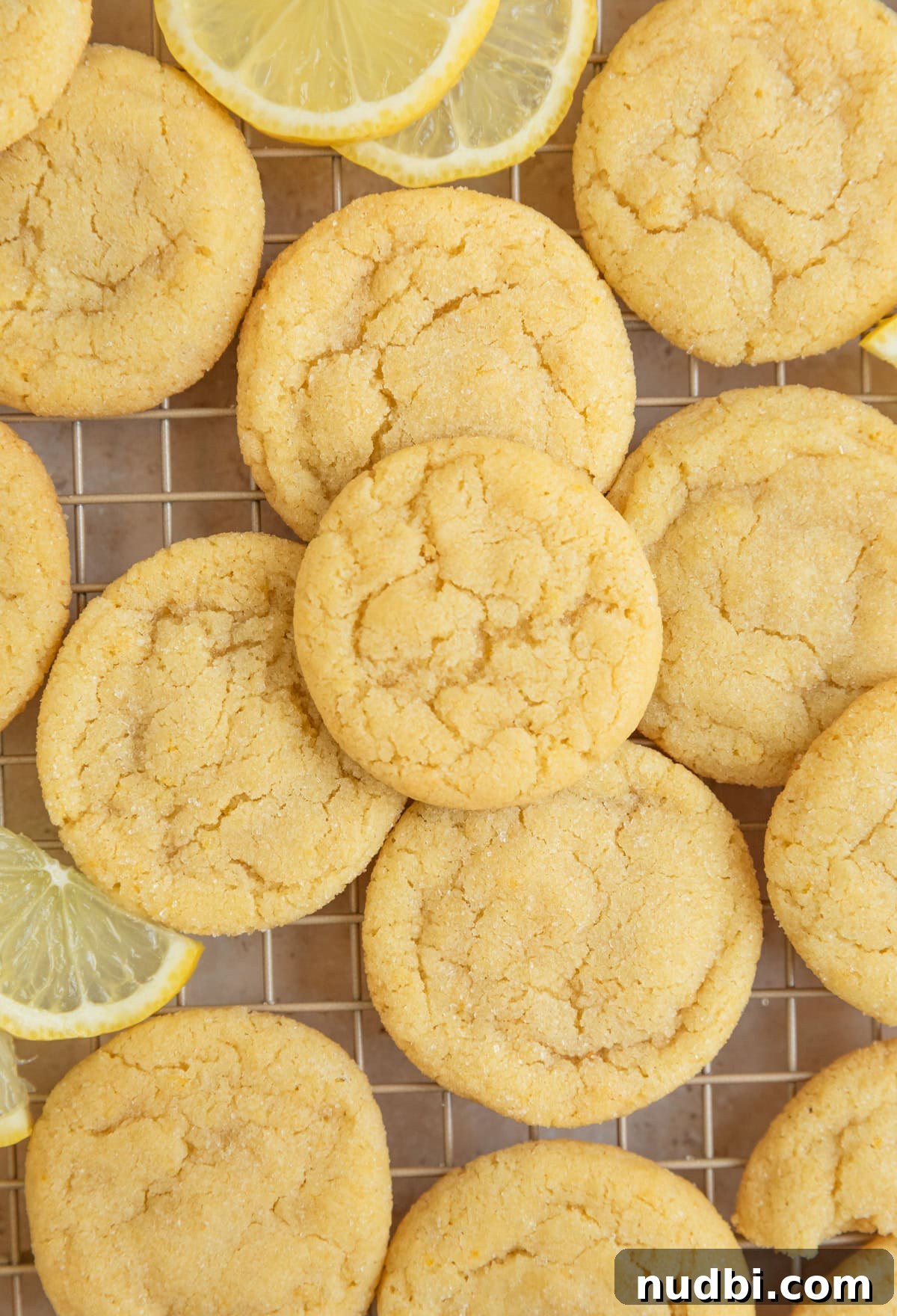 Zesty Lemon Sugar Cookies Recipe for Soft, Crispy Cookies 12 Wire rack with lemon cookies and lemon slices.