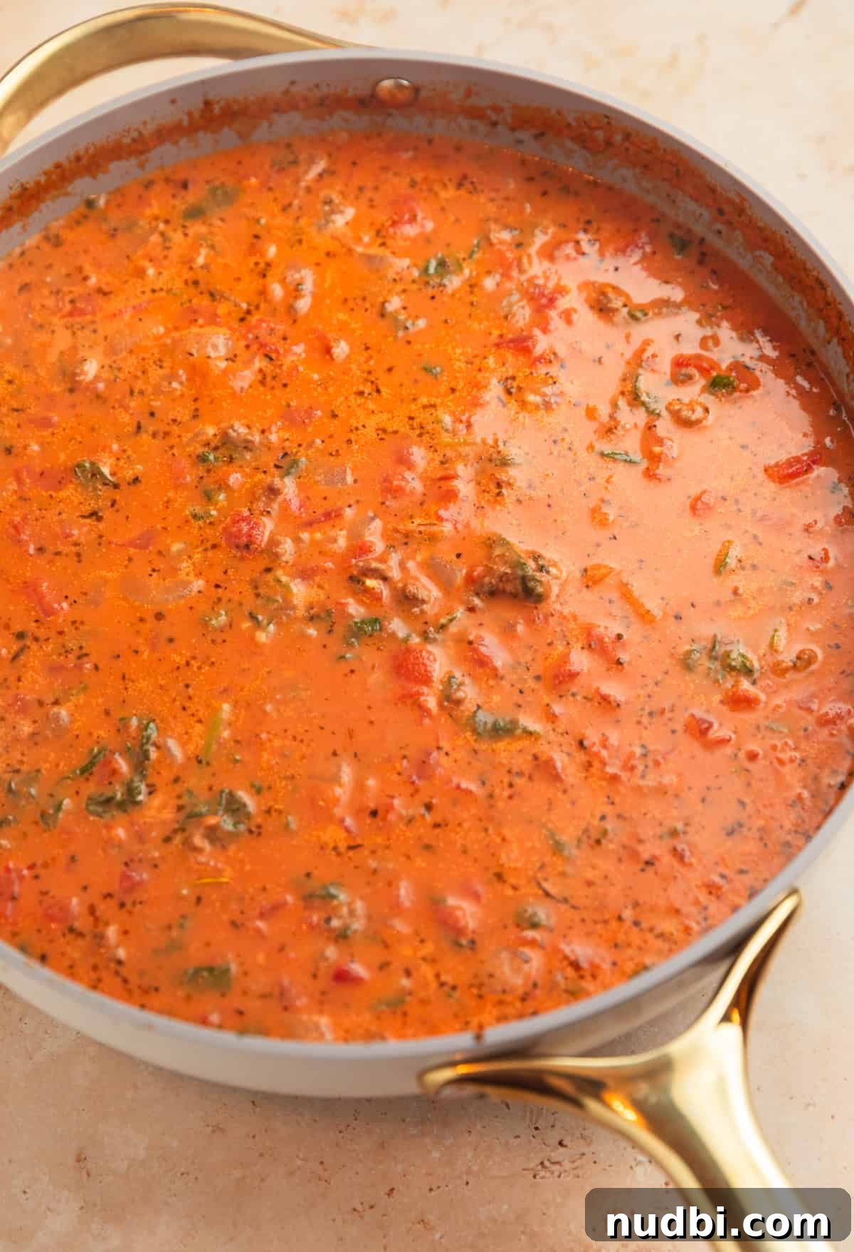 One-Skillet Ground Beef Pasta Skillet Meal 8 Creamy tomato sauce in pan with spinach.