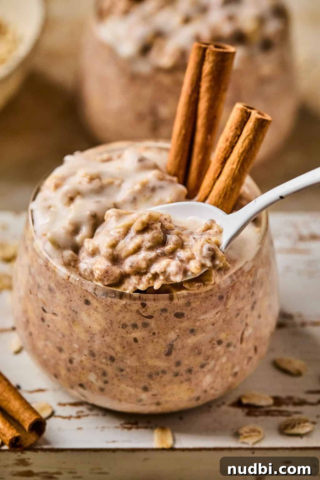 Cinnamon Roll Overnight Oats Recipe for Quick Morning Bliss 6 Spoonful of oatmeal being scooped from cinnamon roll overnight oats bowl.