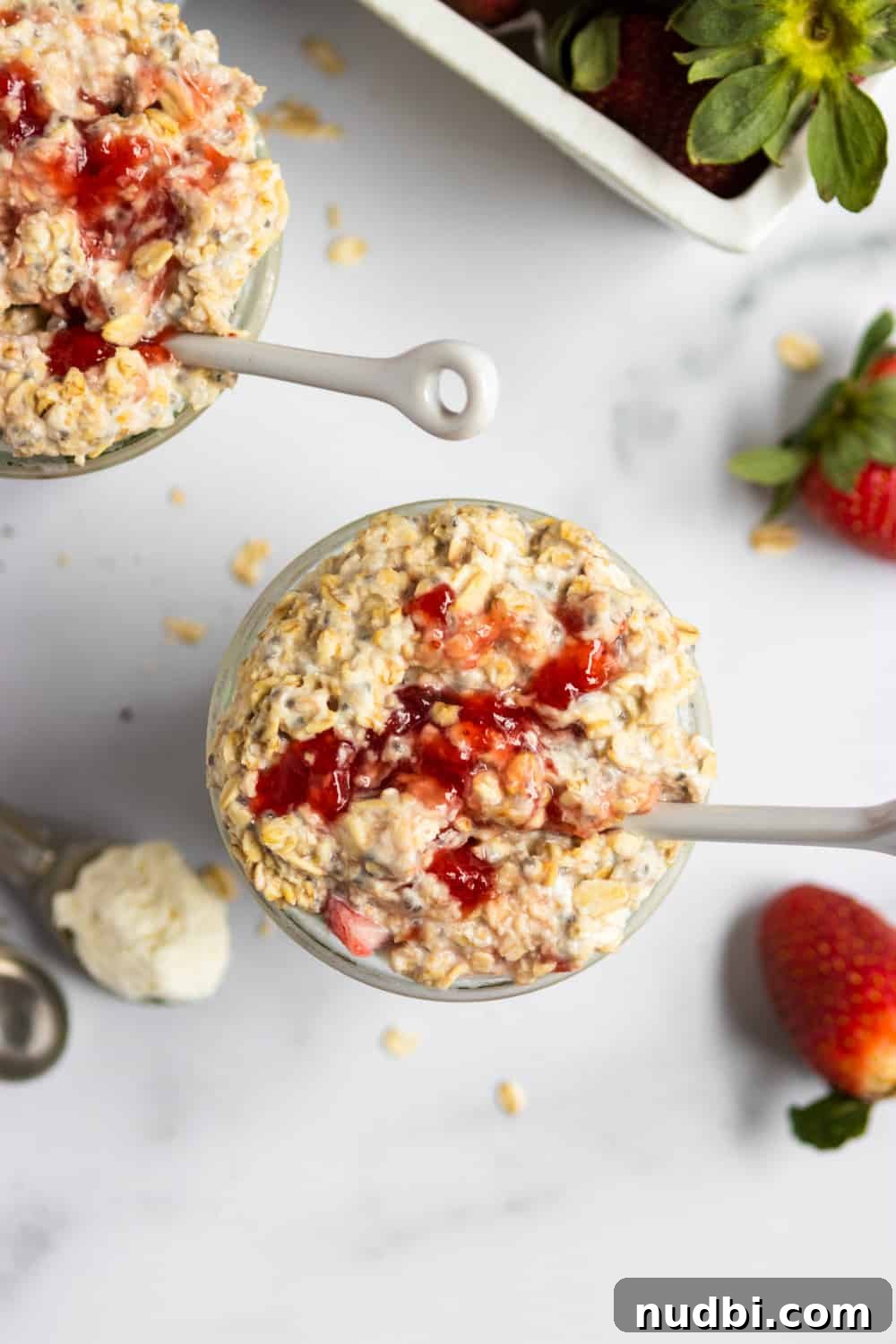 Strawberry Cheesecake Overnight Oats Recipe for Creamy Breakfast 3 Overhead view of jar of strawberry cheesecake overnight oats with white spoon.