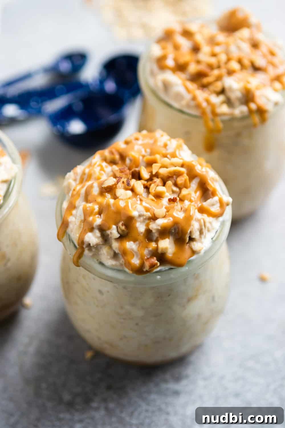 Peanut Butter Cheesecake Overnight Oats Recipe for Creamy Make-Ahead Breakfast 2 Peanut Butter Cheesecake Overnight Oats in jar with crushed peanuts.