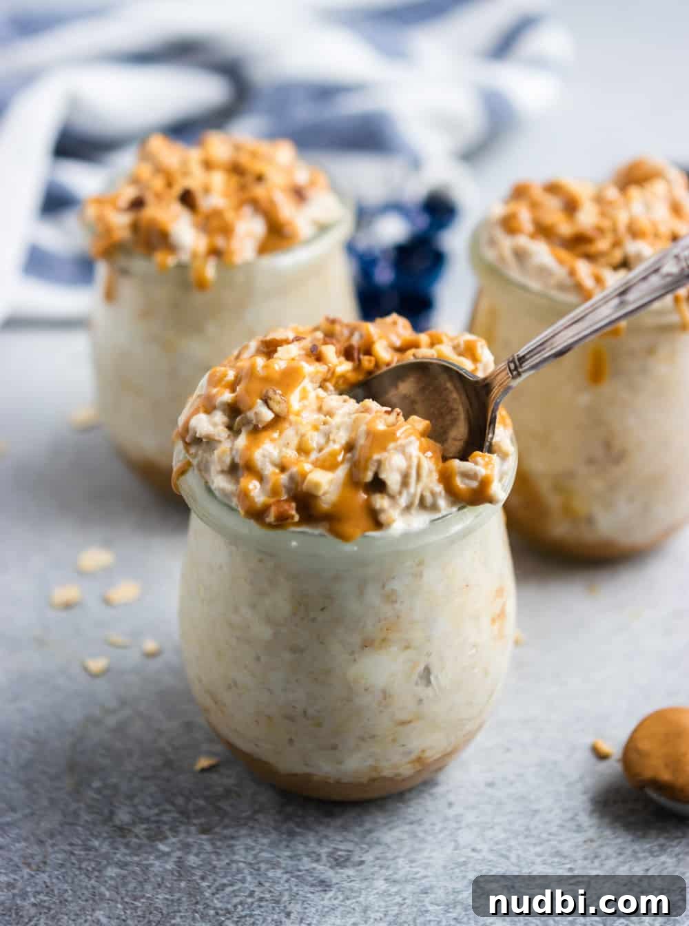 Peanut Butter Cheesecake Overnight Oats Recipe for Creamy Make-Ahead Breakfast 3 Overnight oatmeal in jar with spoon.