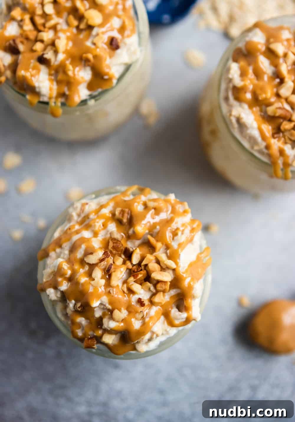 Peanut Butter Cheesecake Overnight Oats Recipe for Creamy Make-Ahead Breakfast 4 Overhead shot of peanut butter oatmeal with peanut butter drizzled over top.