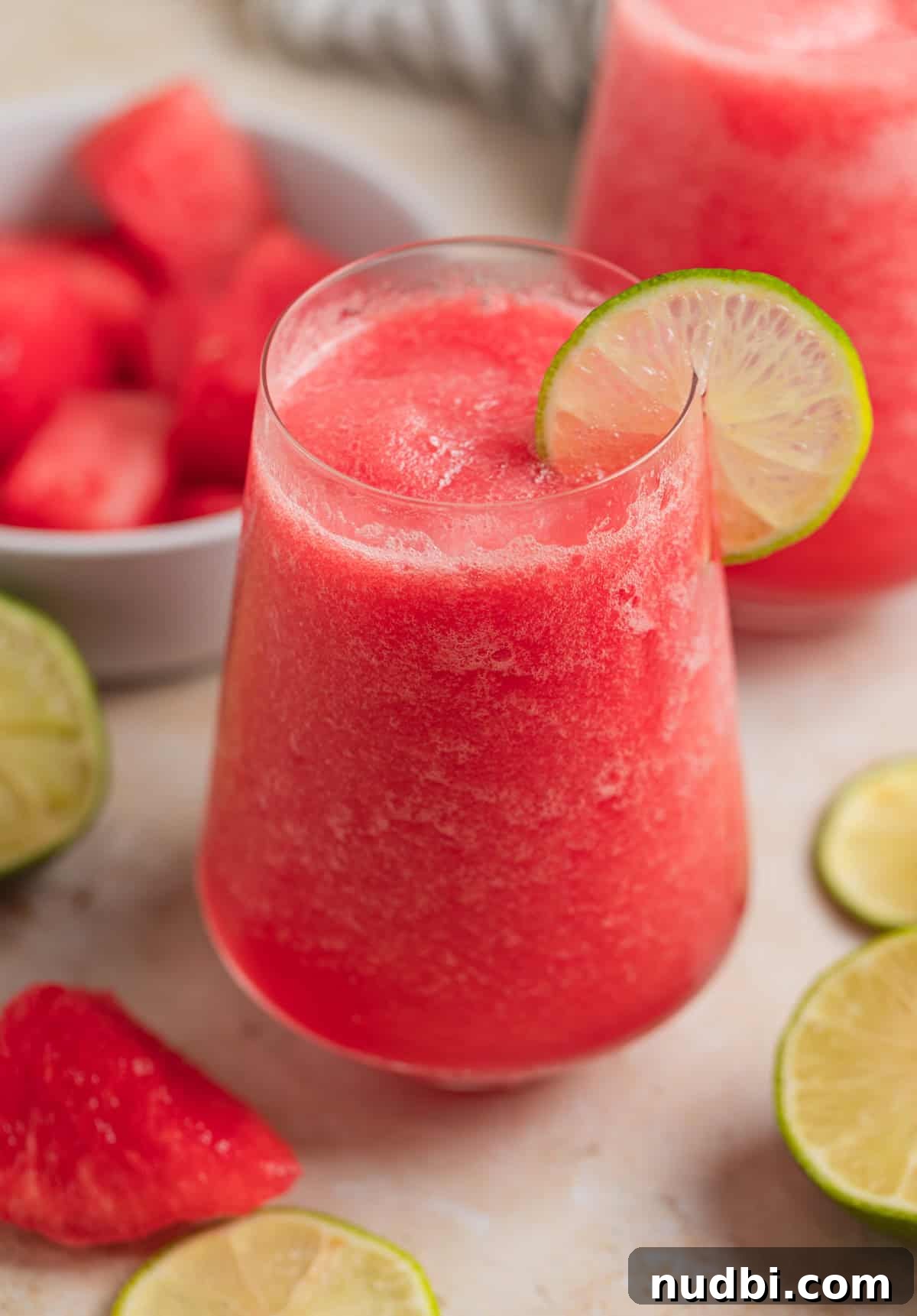 Watermelon Frosé Recipe: Frozen Rosé Cocktail for Summer 3 Glass with watermelon frosé and lime slice to garnish.