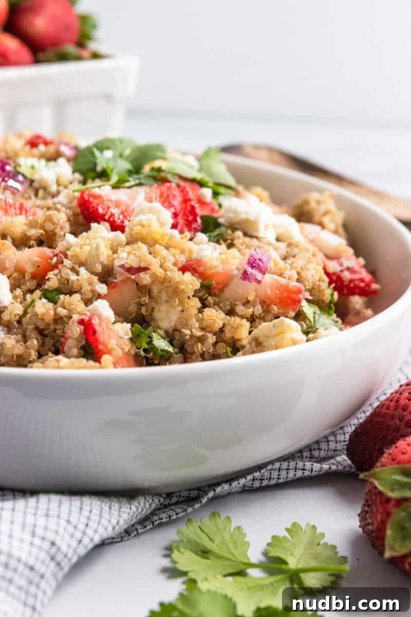Summer Strawberry Quinoa Salad with Basil and Feta 6 Quinoa salad in white serving bowl with napkin.